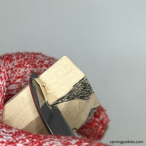 Shaping the back and top of the whittled cat